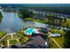 Aerial view of neighborhood community pool and clubhouse on a lake with lush landscaping at 120 Magnolia House Dr, Summerville, SC 29486