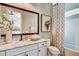 Bathroom featuring marble vanity top, large mirror, updated fixtures, and a shower/tub combo with patterned curtain at 120 Magnolia House Dr, Summerville, SC 29486