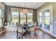 Bright breakfast nook with ample windows, built-in seating, and an elegant chandelier above at 120 Magnolia House Dr, Summerville, SC 29486