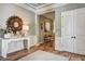 Inviting hallway features elegant decor, wood floors, and a view into a cozy seating area at 120 Magnolia House Dr, Summerville, SC 29486