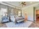 Main bedroom with tray ceilings, a four-poster bed, and an en-suite bathroom for optimal comfort at 120 Magnolia House Dr, Summerville, SC 29486