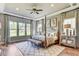 Serene bedroom features tray ceilings, four-poster bed, and large windows for a tranquil setting at 120 Magnolia House Dr, Summerville, SC 29486