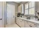 Mudroom features marble countertops, white cabinetry, shuttered windows, and backyard access at 120 Magnolia House Dr, Summerville, SC 29486