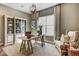 Well-lit office with built-in shelves, a textured rug, and a comfortable chair by the window at 120 Magnolia House Dr, Summerville, SC 29486