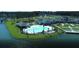 Aerial view of a community pool with lake view and a clubhouse with beautifully landscaped lawn at 120 Magnolia House Dr, Summerville, SC 29486