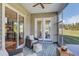 Cozy screened porch with wicker furniture, offering an ideal outdoor living space at 120 Magnolia House Dr, Summerville, SC 29486