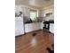 Clean kitchen with white cabinets, modern appliances, and wood-look flooring at 1255 Remount Rd, North Charleston, SC 29406