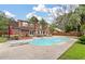 Backyard featuring a pool, deck, and lush landscaping, perfect for outdoor living and entertaining at 129 Dunbury Dr, Summerville, SC 29485