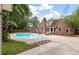 A refreshing pool is surrounded by brick accents, lounge chairs, and manicured greenery, offering a private and serene outdoor space at 129 Dunbury Dr, Summerville, SC 29485