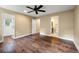 Bedroom with hardwood flooring, a ceiling fan, neutral walls and access to an ensuite bathroom at 129 Dunbury Dr, Summerville, SC 29485