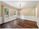 Dining room with hardwood floors, traditional chandelier, and view of the landscaped neighborhood at 129 Dunbury Dr, Summerville, SC 29485