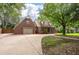 Traditional brick home featuring an attached garage, a long driveway and a well-manicured front lawn at 129 Dunbury Dr, Summerville, SC 29485