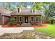 Charming brick home with manicured landscaping, a well-maintained lawn, and welcoming front steps at 129 Dunbury Dr, Summerville, SC 29485