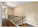 Hallway with hardwood floors, a staircase with decorative railing and neutral walls at 129 Dunbury Dr, Summerville, SC 29485