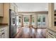 Bright kitchen with stainless steel appliances, granite countertops and hardwood floors overlooking pool and patio at 129 Dunbury Dr, Summerville, SC 29485