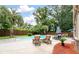 Backyard oasis featuring a pool, lounge chairs, dining area, and lush tropical landscaping at 129 Dunbury Dr, Summerville, SC 29485