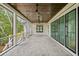 Spacious screened porch with wood ceiling, ceiling fans, and views of the surrounding greenery at 1479 Jeremy Cay Ct, Awendaw, SC 29429