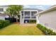 Well-maintained backyard with screened porch access, patio area, lush lawn, and landscaped surroundings at 1517 Willtown St, Charleston, SC 29492