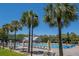 Community pool area featuring lounge chairs, palm trees, and umbrellas, ideal for relaxation and leisure at 1517 Willtown St, Charleston, SC 29492