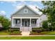 Charming two-story home featuring a welcoming front porch and beautifully landscaped yard at 1517 Willtown St, Charleston, SC 29492