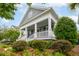 Beautiful home featuring a spacious front porch and lush, mature landscaping at 1517 Willtown St, Charleston, SC 29492