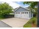 Spacious two-car garage with white doors and ample parking space in a well-maintained area at 1517 Willtown St, Charleston, SC 29492