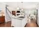 Open kitchen showcasing a large island with cooktop and seamless flow to the living area at 1517 Willtown St, Charleston, SC 29492