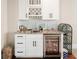 Stylish kitchenette with white cabinetry, granite countertop, wine rack, and beverage fridge at 1517 Willtown St, Charleston, SC 29492