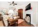 Cozy living room features a classic fireplace, hardwood floors, and comfortable seating at 1517 Willtown St, Charleston, SC 29492