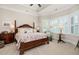 Cozy primary bedroom with a four-poster bed, bay window, and tray ceiling detail at 1517 Willtown St, Charleston, SC 29492