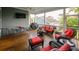 Comfortable screened porch with outdoor seating, ceiling fan, and views of the surrounding neighborhood at 1517 Willtown St, Charleston, SC 29492