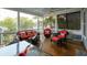Relaxing screened porch with wicker furniture, bright cushions, and a ceiling fan at 1517 Willtown St, Charleston, SC 29492