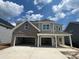 Beautiful two-story home featuring a brick and siding exterior, two-car garage, and a well-manicured front yard at 155 Grange Cir, Summerville, SC 29486
