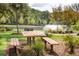 Scenic park picnic area with a wooden table and grill with a fountain as the background at 1754 Cultivation Ln # 513, Mount Pleasant, SC 29466