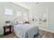 Serene bedroom featuring soft blue bedding, wood floors, and plantation shutters for a peaceful ambiance at 1801 Sandybrook Dr, Mount Pleasant, SC 29466