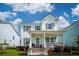 Charming two-story home with a welcoming front porch, landscaped yard, and great curb appeal under a bright sky at 1801 Sandybrook Dr, Mount Pleasant, SC 29466