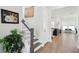 Bright and inviting foyer with hardwood floors, a staircase, and stylish decor creating a warm welcome at 1801 Sandybrook Dr, Mount Pleasant, SC 29466