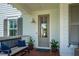 Charming front porch featuring a bench, plants, and a well-lit entrance perfect for relaxing and welcoming guests at 1801 Sandybrook Dr, Mount Pleasant, SC 29466