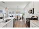 Open concept kitchen with stainless steel appliances, wood floors, and a dining area filled with natural light at 1801 Sandybrook Dr, Mount Pleasant, SC 29466