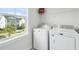 Laundry room with washer, dryer, and window with neighborhood view at 1801 Sandybrook Dr, Mount Pleasant, SC 29466