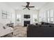 Sunlit living room with a fireplace, modern decor, and comfortable seating arrangement at 1801 Sandybrook Dr, Mount Pleasant, SC 29466
