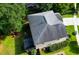 Backyard aerial view of the house, showing lush green grass, screened porch and patio area with firepit at 188 Donning Dr, Summerville, SC 29483