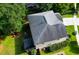 Aerial view of the backyard with a patio area with a fire pit, lush green grass, and mature trees at 188 Donning Dr, Summerville, SC 29483
