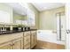 Bathroom featuring tiled floors, a bathtub and shower, and a vanity with black granite at 188 Donning Dr, Summerville, SC 29483