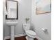 Modern powder room with a pedestal sink, a wall mirror, and a decorative painting at 188 Donning Dr, Summerville, SC 29483