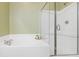 Bright bathroom featuring a tiled tub, separate glass shower, and neutral wall color at 188 Donning Dr, Summerville, SC 29483