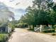 Community entrance featuring a quiet road leading into the community with brick and white fence at 188 Donning Dr, Summerville, SC 29483
