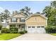 Beautiful two-story home with a two-car garage, well-manicured lawn, and classic architectural details at 188 Donning Dr, Summerville, SC 29483