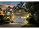 Charming two-story home with a two-car garage and professionally landscaped front yard at sunset at 188 Donning Dr, Summerville, SC 29483