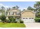 Inviting two-story home with a two-car garage, vibrant green lawn, and charming front entrance at 188 Donning Dr, Summerville, SC 29483